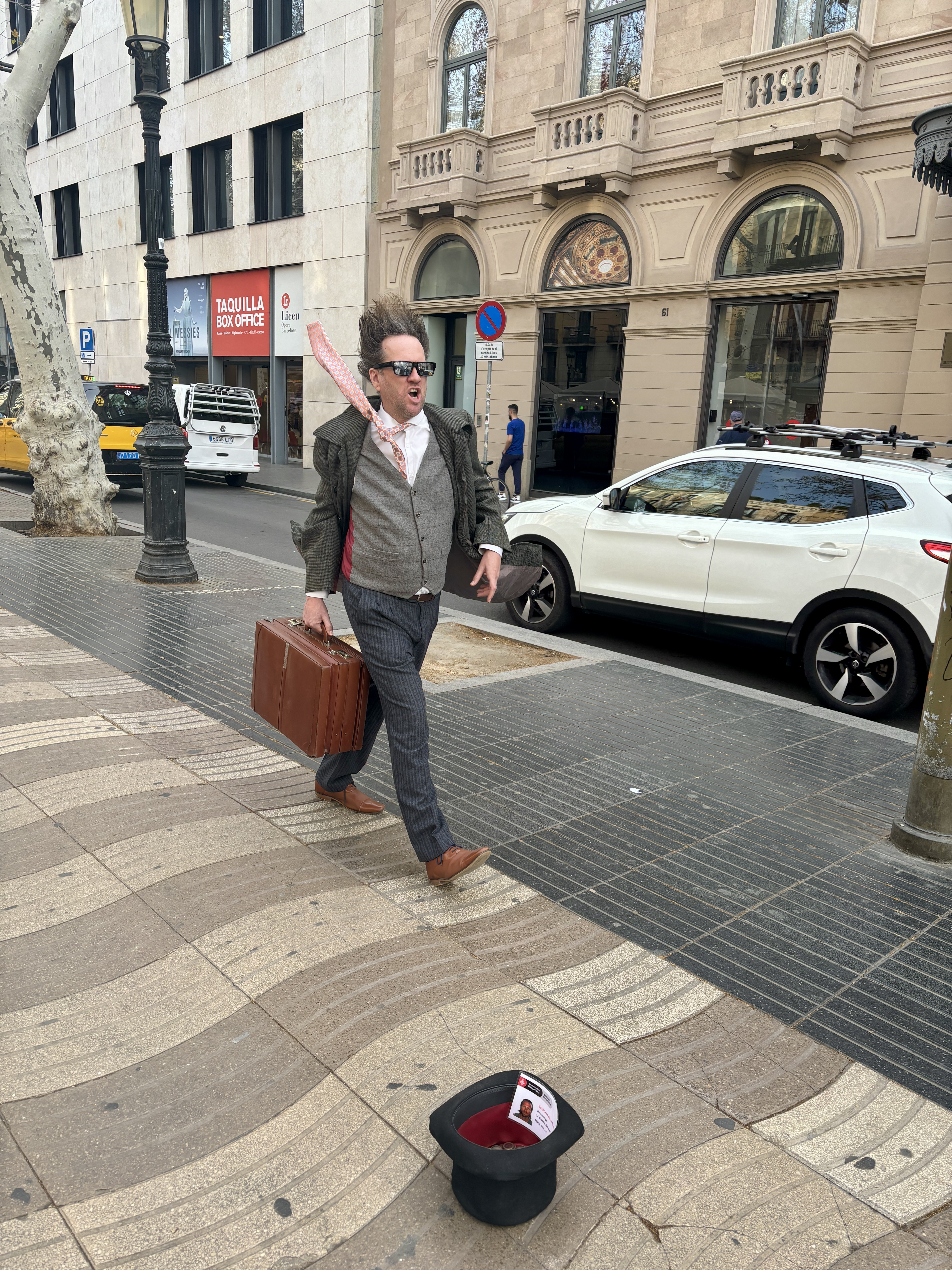 A street illusionist defying wind in Barcelona