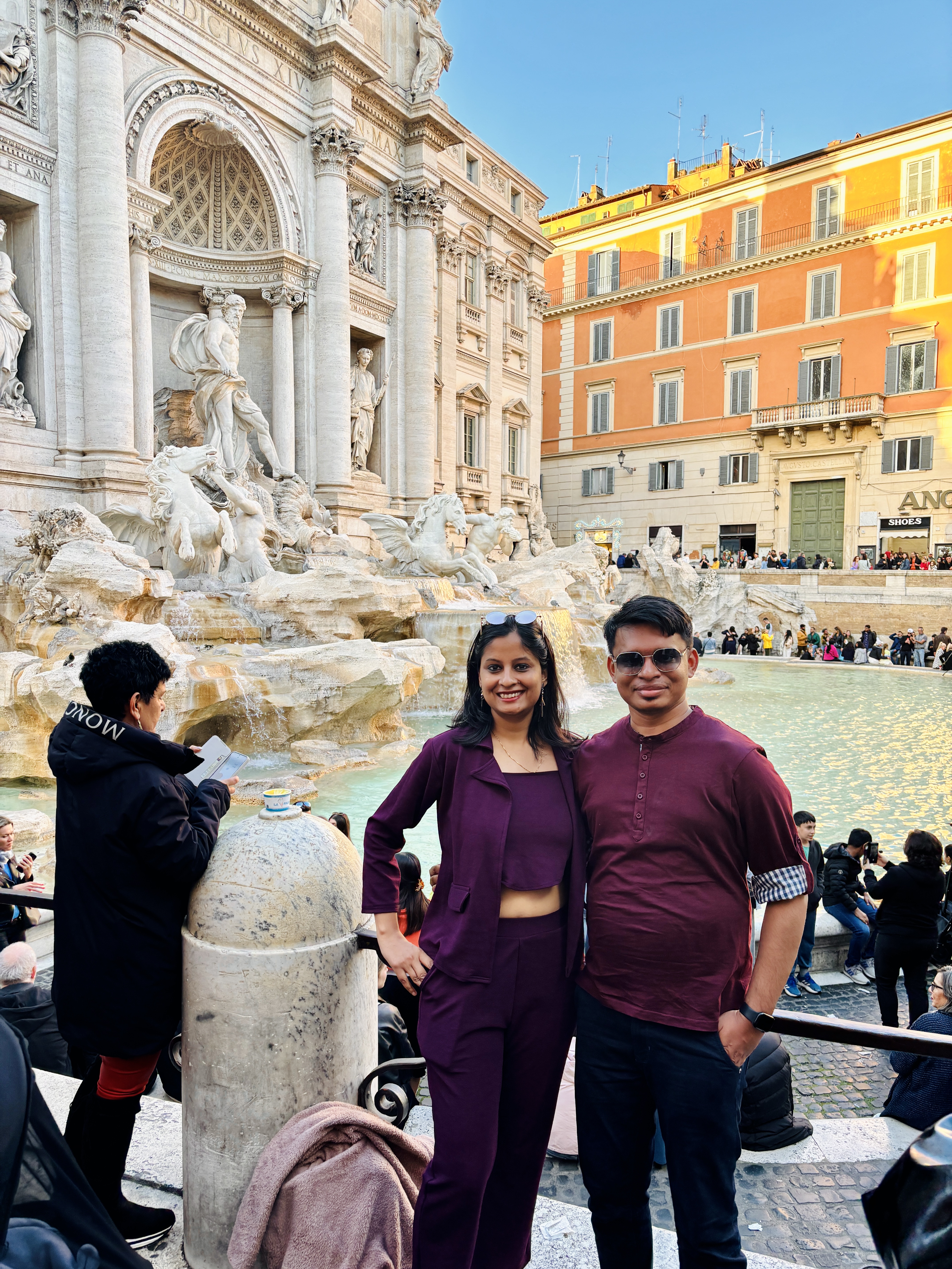 Throwing a wishing coin into the grand Trevi Fountain in Rome