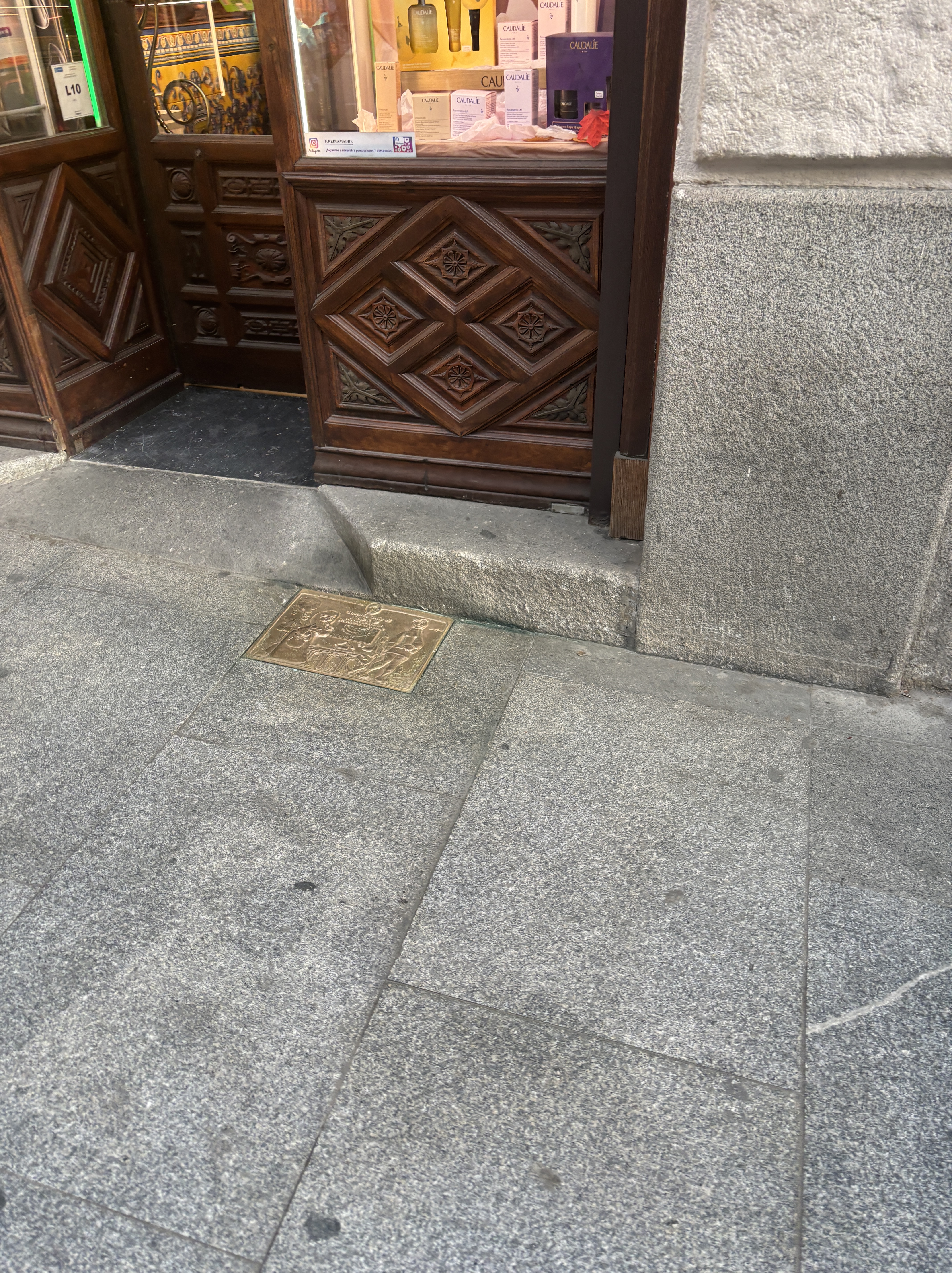 Centenary brass plaque on the street sidewalk