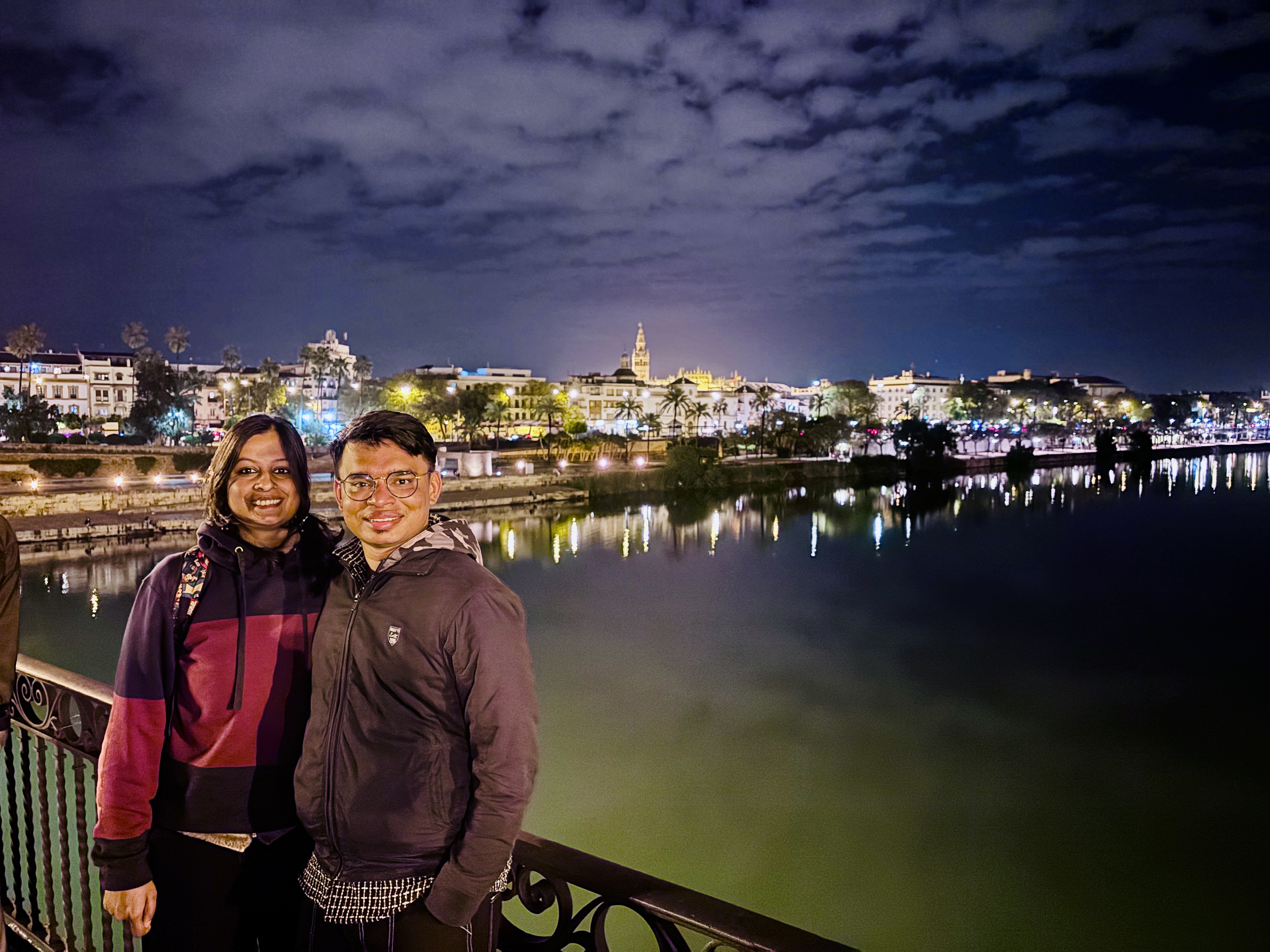 Golden reflections of Seville night skyline in the Guadalquivir River
